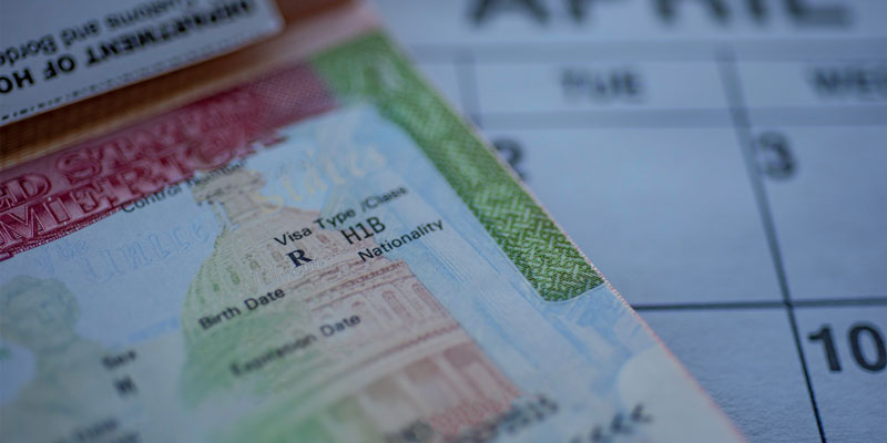 Blurred close up view of a passport with the H1B visa stamped on it