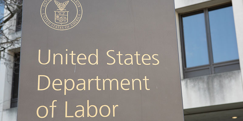 United States Department of Labor and a logo on agrey color board in from of a building in washington DC ,USA