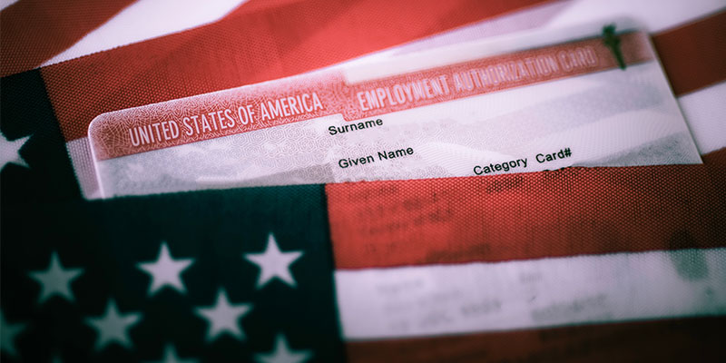 Close up view of Employee Authorization Card covered in the US flag