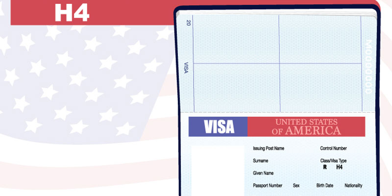 Close-up of a black-and-white H1B visa document against the blurry background of a calendar for April